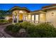 Charming front porch featuring stately columns, elegant lighting, and lush landscaping at 312 Yacht Harbor Dr, Osprey, FL 34229