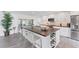 Modern kitchen with sleek white cabinetry, a large island, and stainless steel appliances at 312 Yacht Harbor Dr, Osprey, FL 34229