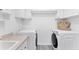 Laundry room with washer, dryer, and ample cabinet space at 312 Yacht Harbor Dr, Osprey, FL 34229
