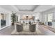 Open-concept living room showcasing stylish seating and seamless flow to the modern kitchen at 312 Yacht Harbor Dr, Osprey, FL 34229