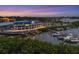 Aerial view of a waterfront marina with boats docked at sunset at 312 Yacht Harbor Dr, Osprey, FL 34229