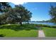 Scenic park with a walking path, benches, and mature trees near the water at 312 Yacht Harbor Dr, Osprey, FL 34229