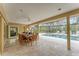 Covered patio with dining, pool, and spa overlooking lush backyard at 312 Yacht Harbor Dr, Osprey, FL 34229