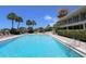 Inviting community pool with lounge chairs and lush landscaping at 312 Yacht Harbor Dr, Osprey, FL 34229