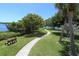 A paved walkway winds through a lush green landscape with benches and picnic tables at 312 Yacht Harbor Dr, Osprey, FL 34229