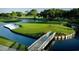 Picturesque golf course with water features and a wooden bridge at 3529 Longmeadow # 15, Sarasota, FL 34235