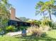 Landscaped backyard with patio and screened enclosure at 3888 Shady Brook Ln, Sarasota, FL 34243