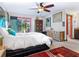 Main bedroom with a king-size bed, access to the patio and unique decor at 3888 Shady Brook Ln, Sarasota, FL 34243