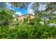 Charming home nestled in a lush, landscaped yard with mature ferns at 3888 Shady Brook Ln, Sarasota, FL 34243