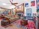 Spacious living room with stone fireplace, eclectic decor and hardwood floors at 3888 Shady Brook Ln, Sarasota, FL 34243