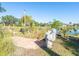 Brick pathway beside a pond with lush landscaping at 3888 Shady Brook Ln, Sarasota, FL 34243