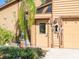 Exterior side entrance with unique decor near the attached garage at 3888 Shady Brook Ln, Sarasota, FL 34243