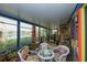 Enclosed sunroom with lake views and comfortable seating area at 3888 Shady Brook Ln, Sarasota, FL 34243