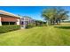 Backyard view of home with screened enclosure and lush landscaping at 4451 Legacy Ct, Sarasota, FL 34241