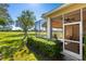 Home exterior showcasing a screened lanai, lush landscaping, and golf course views at 4451 Legacy Ct, Sarasota, FL 34241