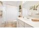 Clean bathroom with white vanity, shower/tub combo, and decorative wall art at 4451 Legacy Ct, Sarasota, FL 34241