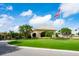 Elegant clubhouse with a flag and manicured lawn at 4451 Legacy Ct, Sarasota, FL 34241