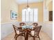 Charming dining area with glass table and wicker chairs at 4451 Legacy Ct, Sarasota, FL 34241
