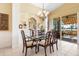 Elegant dining room with glass table and chandelier at 4451 Legacy Ct, Sarasota, FL 34241
