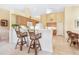 Bright kitchen with island, breakfast bar, and view to backyard at 4451 Legacy Ct, Sarasota, FL 34241