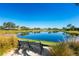 Serene lake view with a bench, ideal for relaxing outdoors at 4451 Legacy Ct, Sarasota, FL 34241