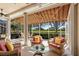 Relaxing sunroom with wicker furniture and view of the golf course at 4451 Legacy Ct, Sarasota, FL 34241