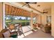 Bright sunroom with seating area and golf course view at 4451 Legacy Ct, Sarasota, FL 34241