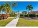 Pathway through lush landscaping leading to a community pool at 4451 Legacy Ct, Sarasota, FL 34241