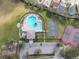 A high aerial shot of the community pool, basketball court, tennis courts and playground at 4514 Sanibel Way, Bradenton, FL 34203