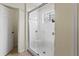 Bathroom with tiled shower, glass enclosure, and bright lighting at 4514 Sanibel Way, Bradenton, FL 34203