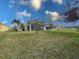 Backyard view of one-story house with screened patio at 4514 Sanibel Way, Bradenton, FL 34203