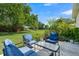 Spacious backyard with lush green grass and trees at 5200 Highbury Cir, Sarasota, FL 34238