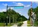 Entrance to The Legacy Trail with palm trees and a railroad crossing at 5200 Highbury Cir, Sarasota, FL 34238