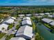 Aerial view of villas, lake, and lush landscaping at 5478 Kelly Dr # 7, Sarasota, FL 34233