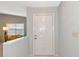 Bright entryway with white door and view to living room at 5478 Kelly Dr # 7, Sarasota, FL 34233