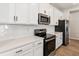 Modern kitchen with stainless steel appliances and white shaker cabinets at 5967 Timberdale Ave, Wesley Chapel, FL 33545