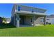 Two-story home with covered patio and green lawn at 6107 116Th E Ave, Parrish, FL 34219