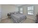 Cozy bedroom with striped bedding and ample natural light at 6107 116Th E Ave, Parrish, FL 34219
