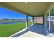 Covered patio overlooking a pond and lush landscape at 6107 116Th E Ave, Parrish, FL 34219