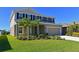 Two-story house with gray siding, black shutters, landscaping, and a large lawn at 6107 116Th E Ave, Parrish, FL 34219