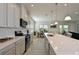 Open concept kitchen with stainless steel appliances, white cabinets, and a large island at 6107 116Th E Ave, Parrish, FL 34219