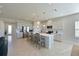 Open concept kitchen with large island, stainless steel appliances, and white cabinets at 6107 116Th E Ave, Parrish, FL 34219