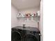 Functional laundry room with washer, dryer, and shelving at 6107 116Th E Ave, Parrish, FL 34219
