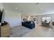 Open living space with a comfortable couch, and views into the kitchen and dining area at 6107 116Th E Ave, Parrish, FL 34219