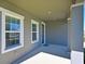 Covered porch with gray exterior and white trim at 6107 116Th E Ave, Parrish, FL 34219