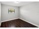 Simple bedroom with dark tile floors and one window at 6513 Malaluka Rd, North Port, FL 34287