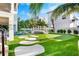 Landscaped backyard with putting green and unique bridge at 741 Jacaranda Rd, Anna Maria, FL 34216