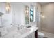 Modern bathroom with a walk-in shower and marble vanity at 741 Jacaranda Rd, Anna Maria, FL 34216