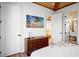 Bedroom with mid-century modern dresser and en-suite bathroom at 741 Jacaranda Rd, Anna Maria, FL 34216