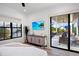Bedroom with private balcony access and a large TV at 741 Jacaranda Rd, Anna Maria, FL 34216